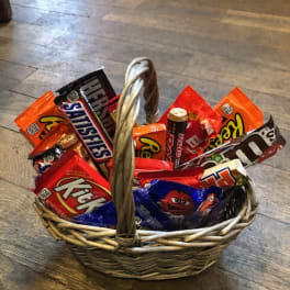 Wicker basket filled with assorted candy bars and chocolates