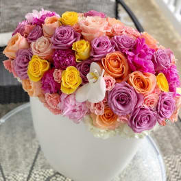 Colorful bouquet of roses in a white vase