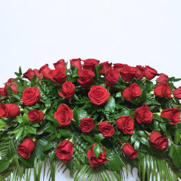 Large arrangement of red roses with dense greenery