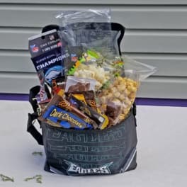 Gift basket with snacks and candy in an Eagles tote bag