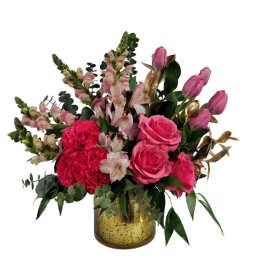 Pink roses and carnations in a gold vase with mixed greenery