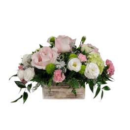 Pink and white floral arrangement in a wooden box