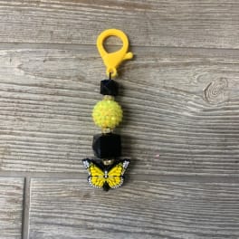 Yellow butterfly beaded charm with black beads and a clip