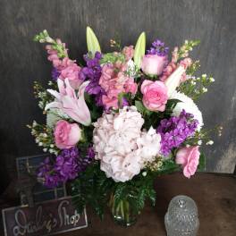 Pink and purple mixed bouquet in a glass vase
