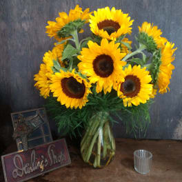 Bouquet of yellow sunflowers in a glass vase
