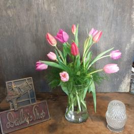 Pink and purple tulips in a clear glass vase