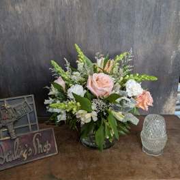 Pink and white floral arrangement in a glass vase