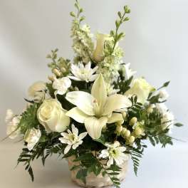 Creamy white floral arrangement in a woven basket
