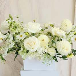 White floral arrangement in a rectangular white box