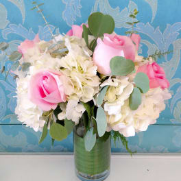 Pink roses and white hydrangeas in a glass vase