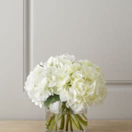 White hydrangea bouquet in a clear glass vase