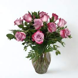Pink roses arranged in a clear glass vase