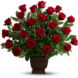 Red roses arranged in a brown urn vase