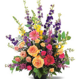 Colorful mixed flower arrangement in a black vase
