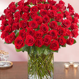 Large bouquet of red roses in a clear glass vase