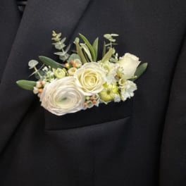 White floral boutonniere on a black suit jacket