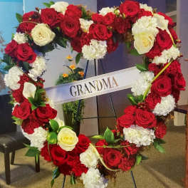 Heart-shaped floral wreath of red and white roses with a GRANDMA sign