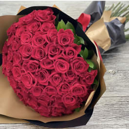 Bouquet of hot pink roses wrapped in brown and black paper