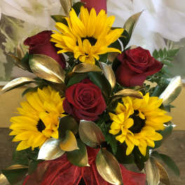 Bouquet of red roses and yellow sunflowers with a red ribbon