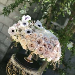 Blush and white rose bouquet with white anemones on an ornate stand