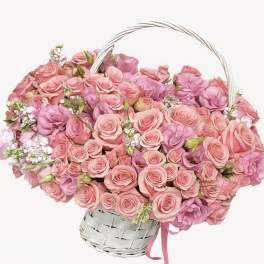 Basket of pink roses and purple blooms with a white handle