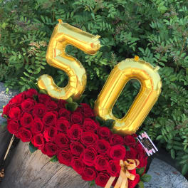 Red rose arrangement with gold "50" balloons