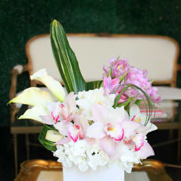 Pink and white floral arrangement in a white vase