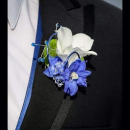 White and blue boutonniere pinned to a suit jacket