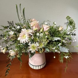 Loose pastel bouquet in a pink ceramic vase