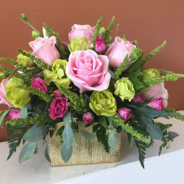 Pink and green rose bouquet in a gold rectangular container