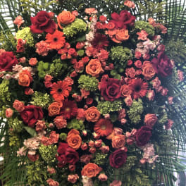 Heart-shaped floral arrangement with roses and gerbera daisies
