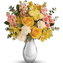 Yellow and pink mixed flower bouquet in a clear glass vase