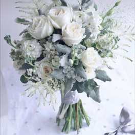 White rose bouquet with silvery foliage and a ribbon wrap