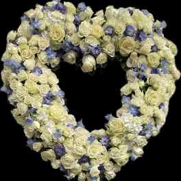 Heart-shaped floral arrangement of white roses and blue flowers