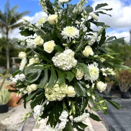 Large white floral standing spray with roses and chrysanthemums