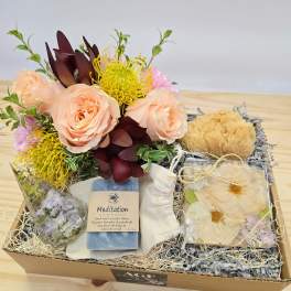 Gift box with peach roses, yellow flowers, soap, and dried floral accents