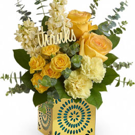Yellow roses and cream carnations in a decorative box with a "thanks" sign