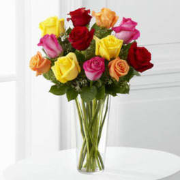 Bouquet of multicolored roses in a clear glass vase