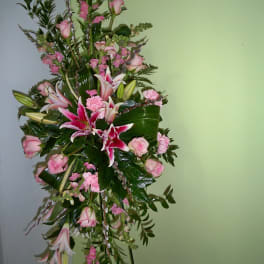 Tall pink and white floral standing spray with lilies and roses