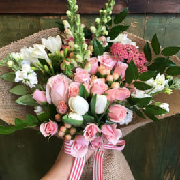 Pink rose bouquet with white tulips and a striped ribbon