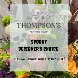 Spooky seasonal flower arrangement with skull decorations and mixed blooms
