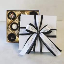 Box of assorted chocolates tied with black and white ribbon