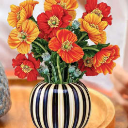 Orange and red poppy bouquet in a striped vase