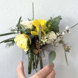 Small bouquet with yellow and white roses and greenery