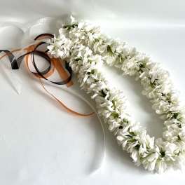 White floral lei with black, orange, and white ribbons