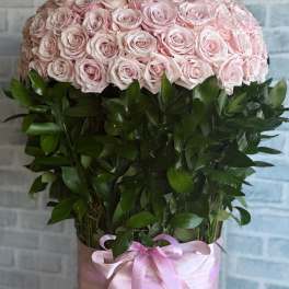 Large pink rose arrangement topped with a jeweled crown