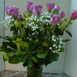 Pink roses with baby's breath in a glass vase