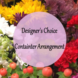 Designer’s choice container arrangement with mixed colorful flowers