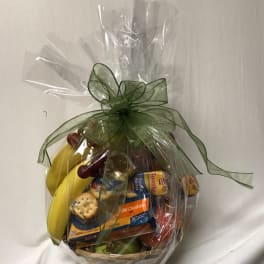 Gift basket with fruit and packaged snacks wrapped in clear cellophane