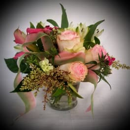 Pink and cream bouquet in a clear glass vase